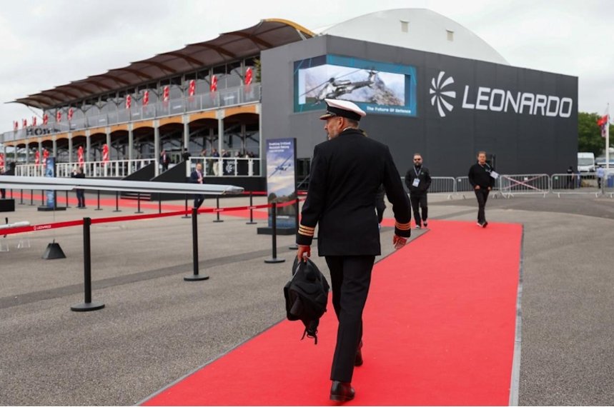 Leonardo aerospace exhibition with naval officer on red carpet